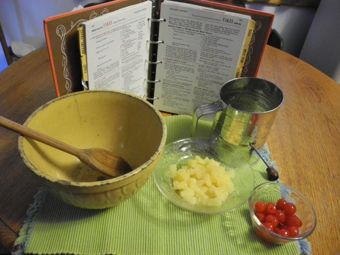 BACK-IN-THE-DAY BAKING ITEMS -- Grandma Anna Kollar's mixing bowl and mixing spoon are in my possession and in the picture. The sifter is mine but seldom used. These would be some of the utensils used back in the 1940s to make a fruit cake. There are many recipes for the dried fruit-filled, spicy cake. Three are listed here, along with one for figgy pudding, an English treat for Christmas. -- Esther McCoy